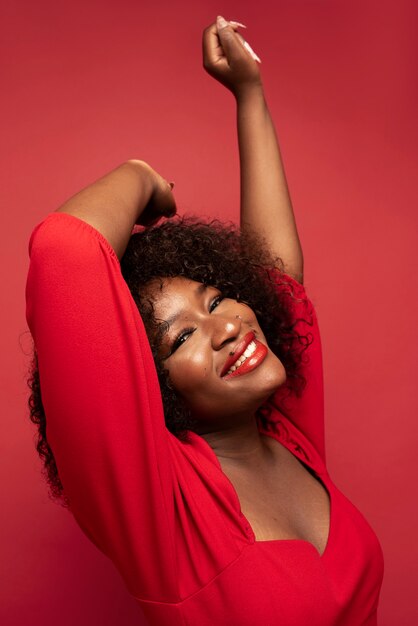 Portrait of young beautiful woman with red dress