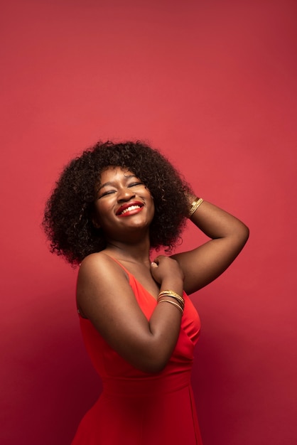 Portrait of young beautiful woman with red dress