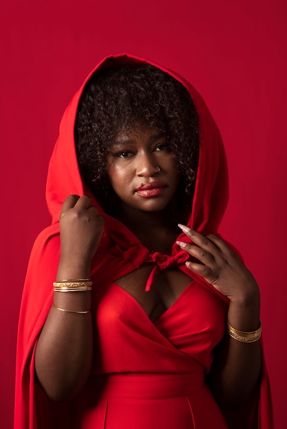 Portrait of young beautiful woman with red dress