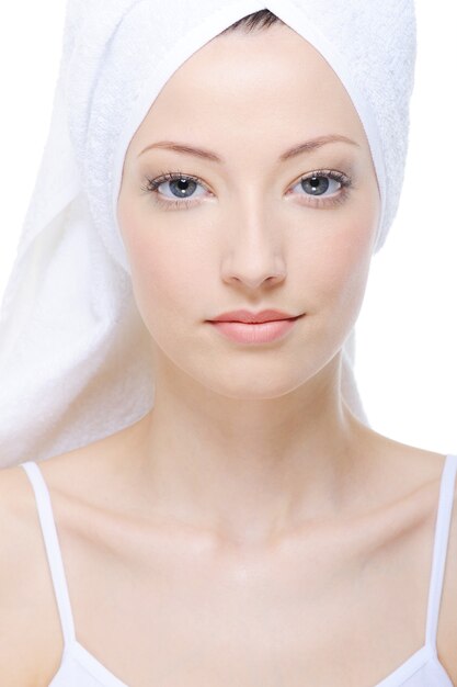 Portrait of young beautiful woman with towel on her head