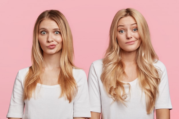 Portrait of young blonde female friends posing