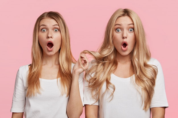 Portrait of young blonde female friends posing