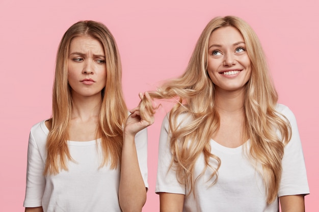 Portrait of young blonde female friends posing