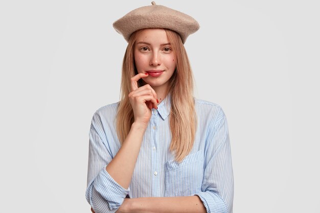 Portrait of young blonde woman wearing beret