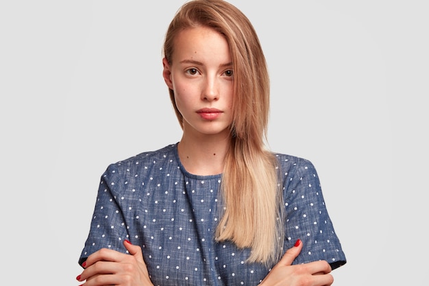 Portrait of young blonde woman wearing polka dot blouse