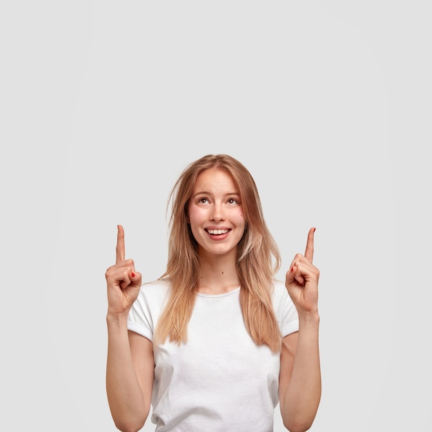 Portrait of young blonde woman in white T-shirt