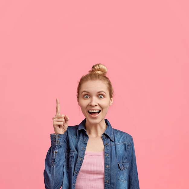 Free photo portrait of young blonde woman with hair in a bun