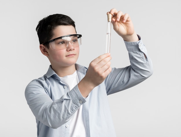 Portrait of young boy checking chemistry sample