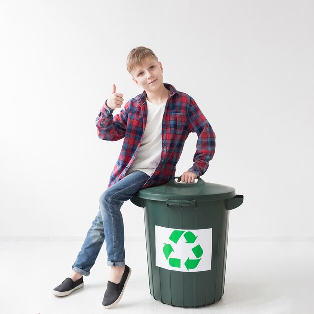 Portrait of young boy happy to recycle