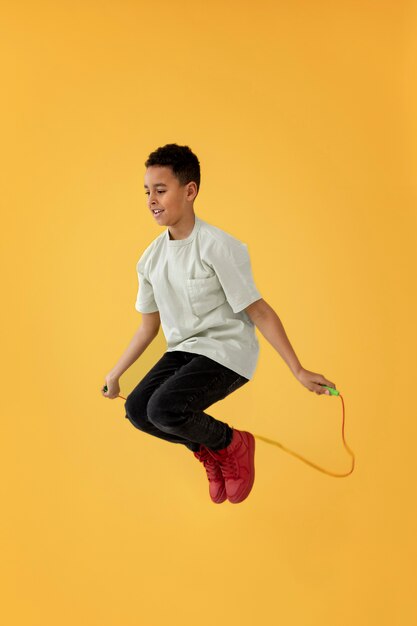 Portrait of young boy jumping rope