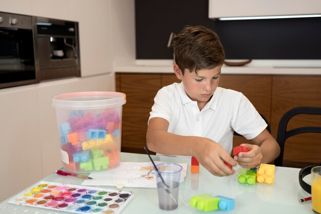 Portrait of young boy playing at home