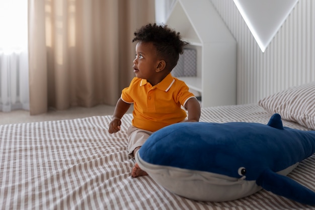 Free photo portrait of young boy playing with his stuffed animal toy