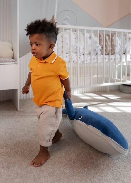 Portrait of young boy playing with his stuffed animal toy