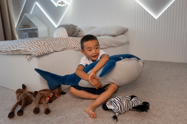 Portrait of young boy playing with his stuffed animal toy