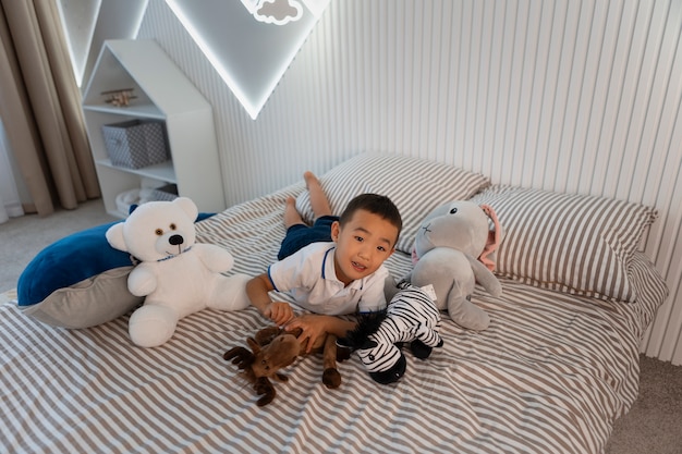 Portrait of young boy playing with his stuffed animal toy