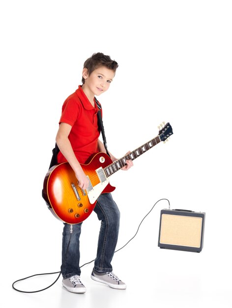 Portrait of young boy with a electric guitar isolated on white