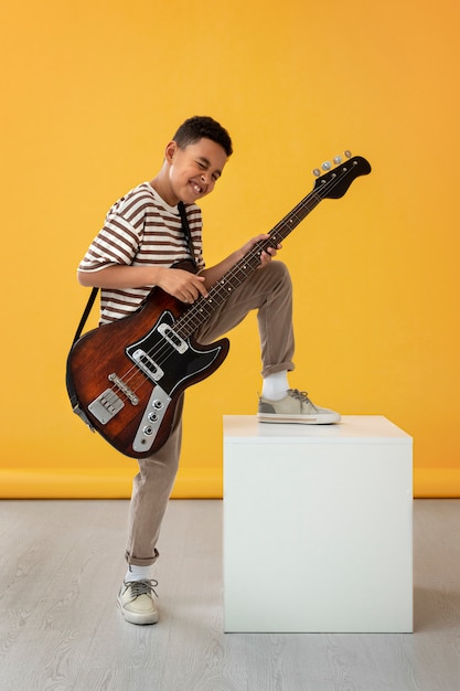 Portrait of young boy with guitar