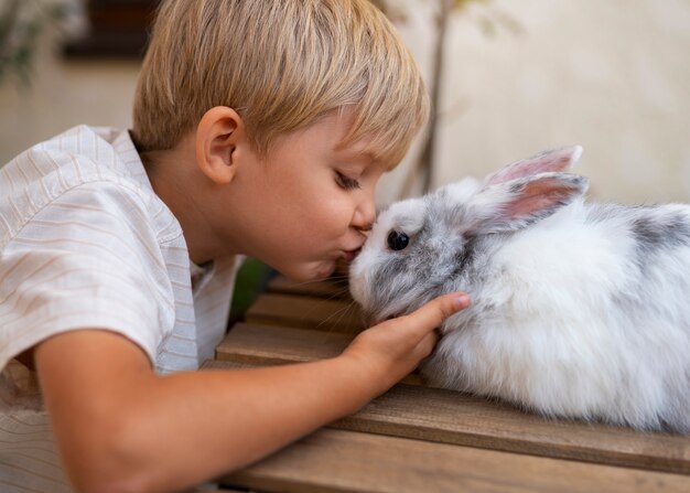 portrait of young boy with his pet rabbit