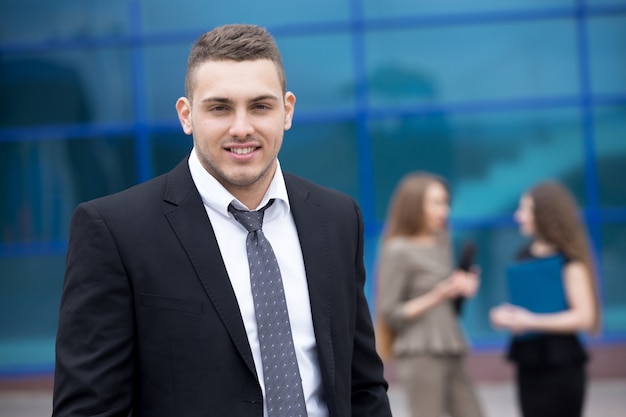 Portrait of young business man looking at camera