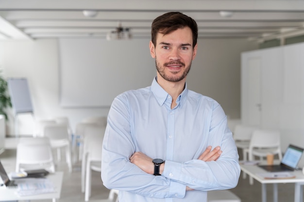 Portrait of young business man posing with crossed arms