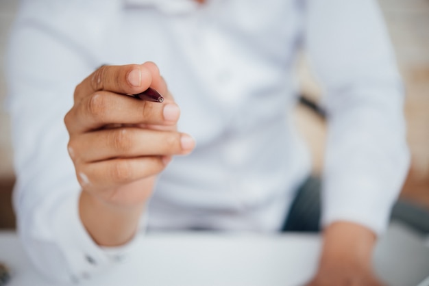 Portrait of young business man sitting at his desk 