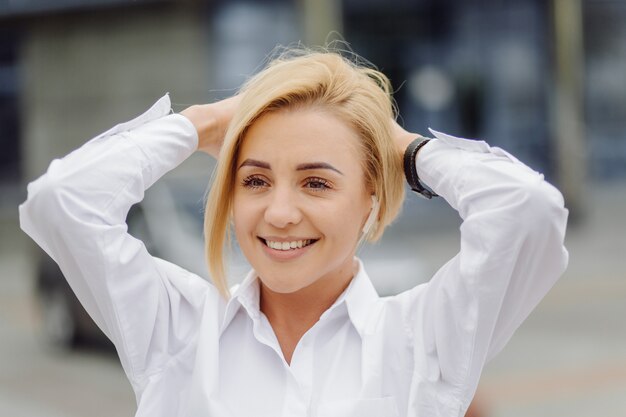 Portrait of a young business woman blonde smiling 