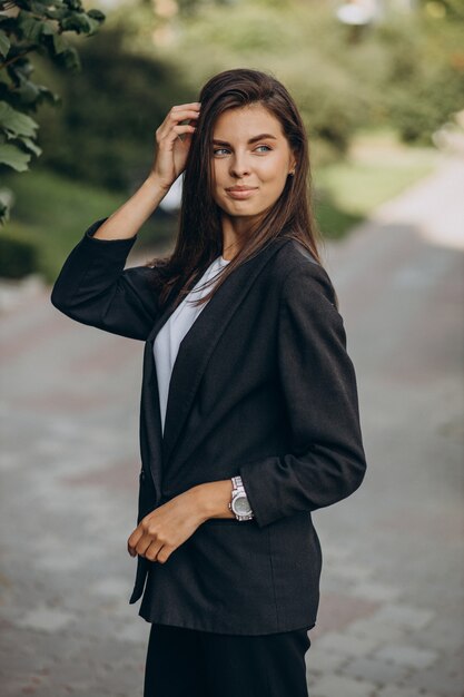 Portrait of young business woman in park