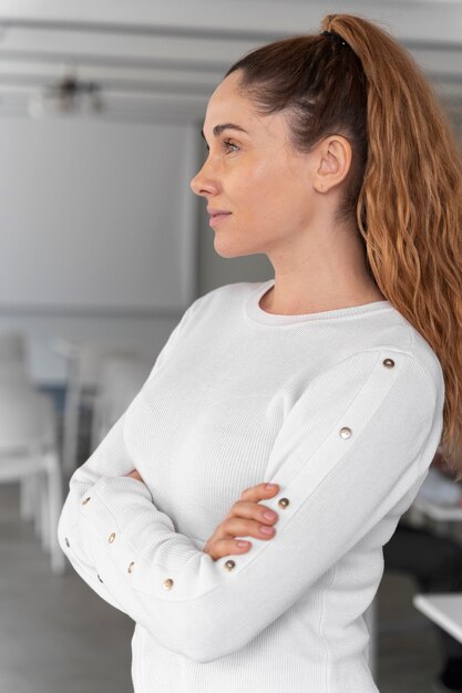 Portrait of young business woman posing with crossed arms