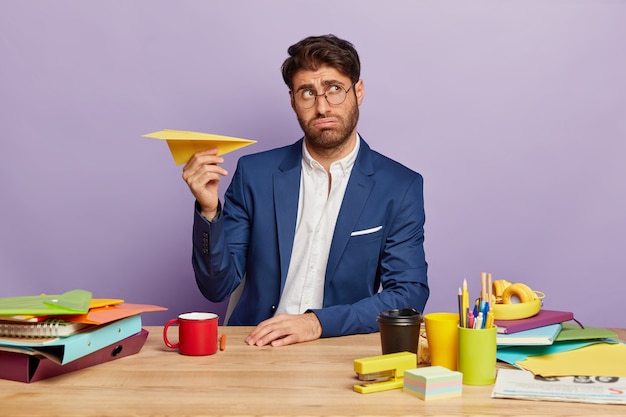 Portrait of young businessman sitting at the office desk