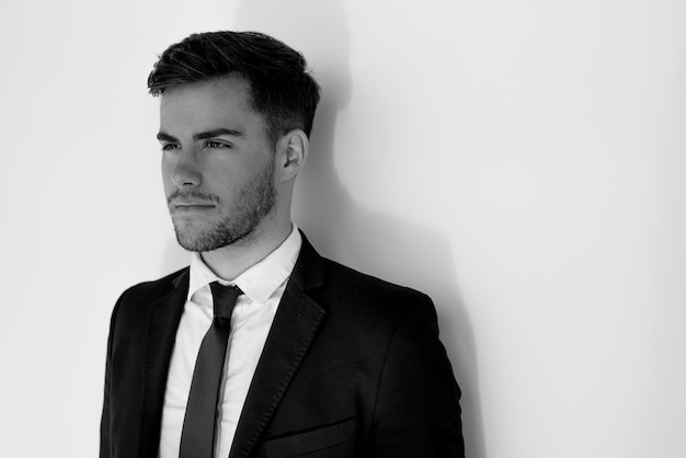 Portrait of young businessman smiling at the airport with suit