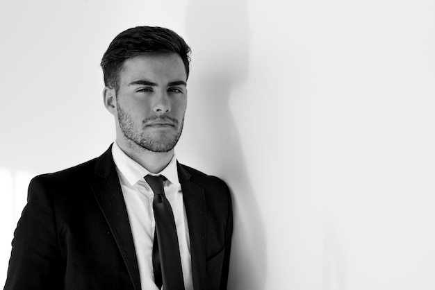 Portrait of young businessman smiling at the airport with suit