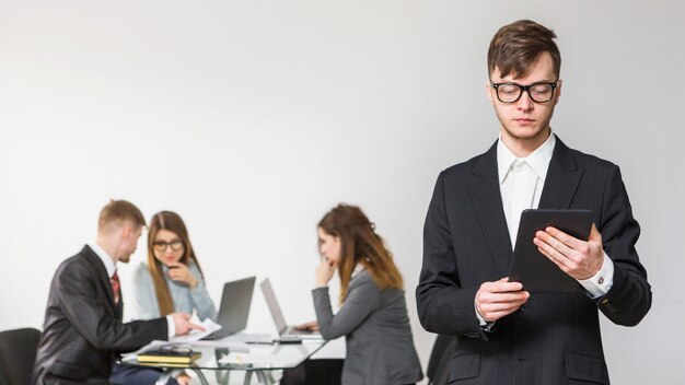 Portrait of a young businessman using digital tablet