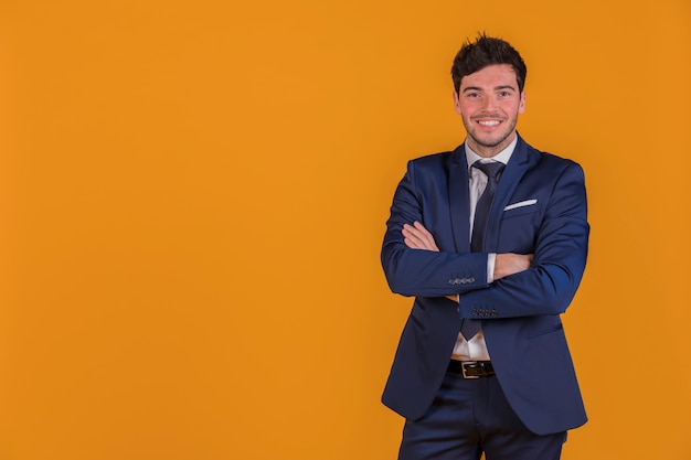 Portrait of a young businessman with his arm crossed looking at camera