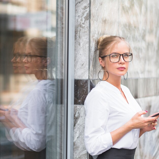 Portrait of a young businesswoman holding mobile phone