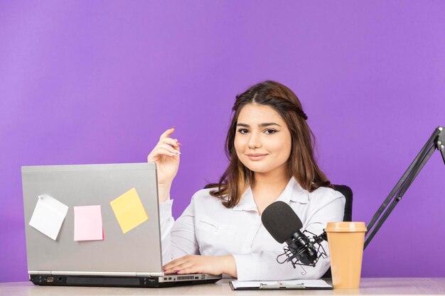 Portrait of a young businesswoman sitting behind the desk and looking at the camera High quality photo