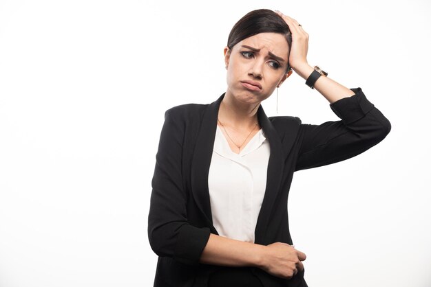 Portrait of young businesswoman touching her head .