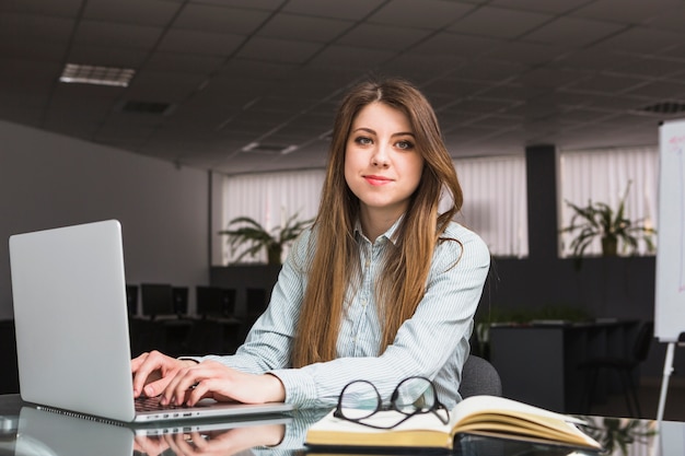 Portrait of a young businesswoman using laptop