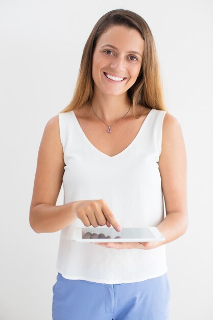 Portrait of young businesswoman using touchpad