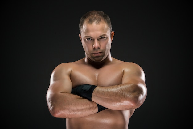 portrait of young caucasian boxer with folded hands posing