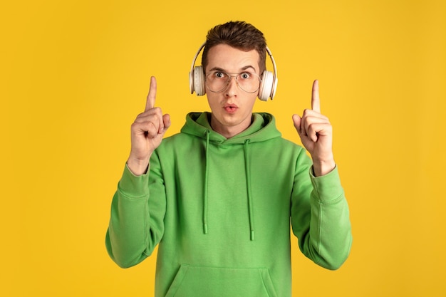 Portrait of young caucasian man isolated on yellow  wall