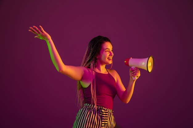 Portrait of young caucasian woman on pink