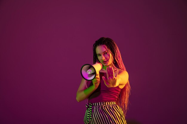 Portrait of young caucasian woman on pink