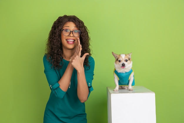 Portrait of young caucasian woman with bright emotions on green