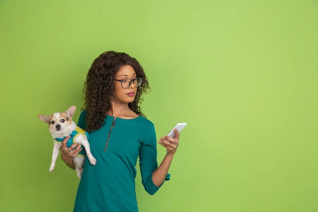 Portrait of young caucasian woman with bright emotions on green