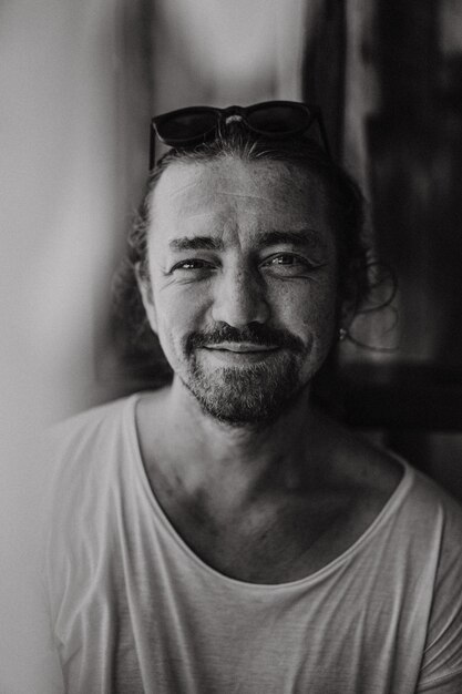 Portrait of a young charismatic man, black and white, close-up, emotional, soft light, shadows.