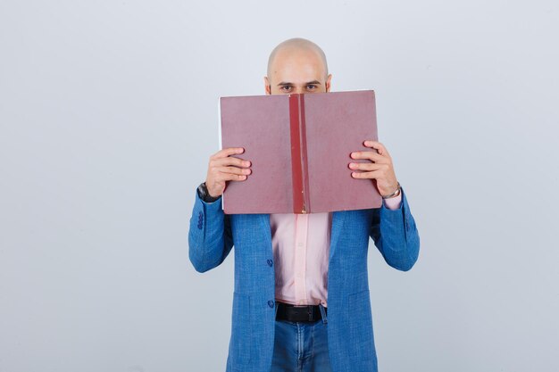 Portrait of a young cheerful man holding a book