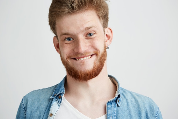 Portrait of young cheerful merry guy making funny face fooling.