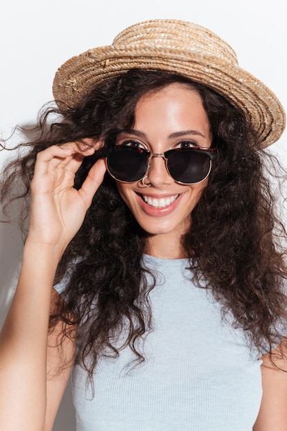 Portrait of young cheerful woman in sunglasses