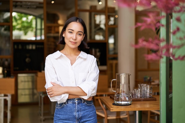 Portrait of young confident asian businesswoman cross arms on chest looking confident standing near