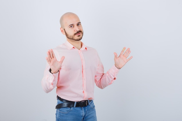 Portrait of a young confident man showing palms